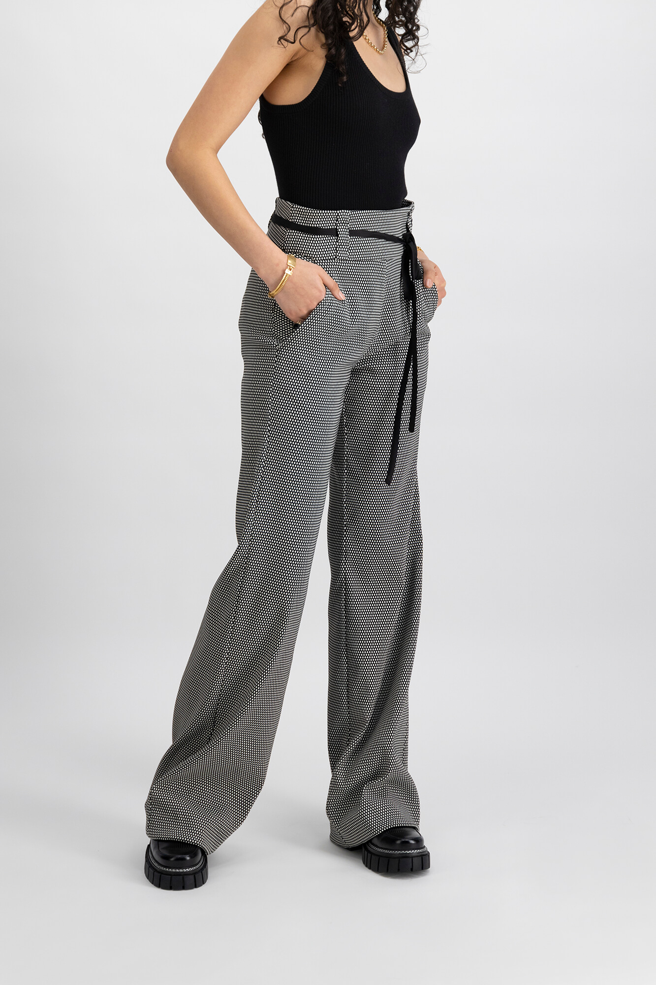 Taylor Boutique patterned pants worn by female model close up crop shot